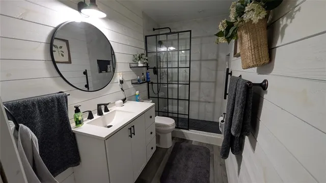a bathroom with a sink toilet and shower