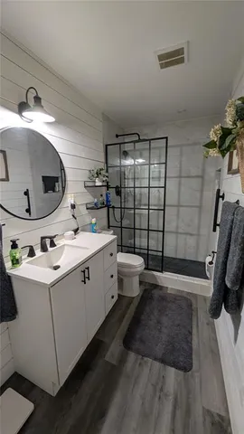 a bathroom with a double vanity sink toilet and shower
