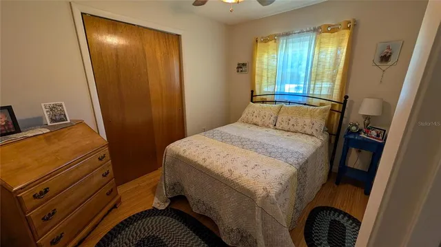 a bedroom with a bed and a mirror