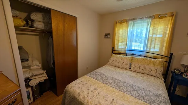 a bedroom with a bed and a window