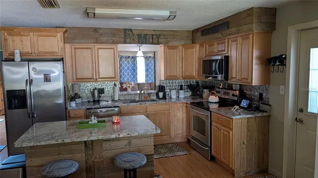 a kitchen with a sink stove and refrigerator