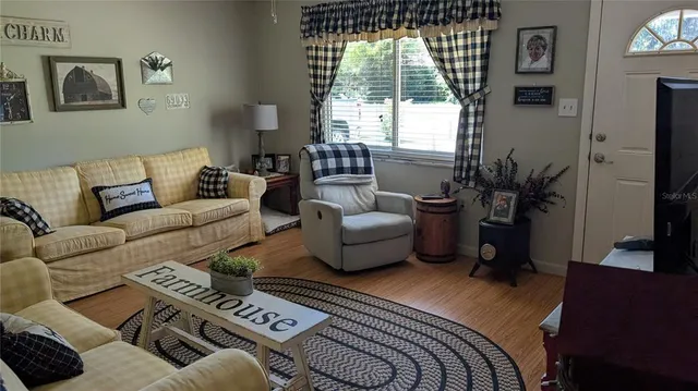 a bedroom with furniture and a large window