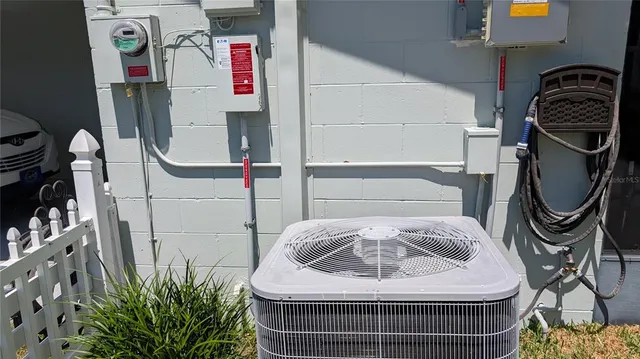 a view of a house with wooden fence and a large tree