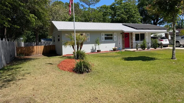 a front view of a house with a yard table and chairs