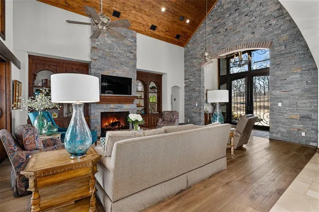 a living room with furniture a fireplace and a flat screen tv