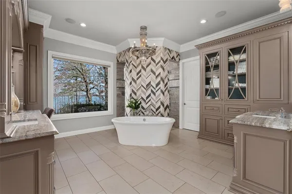 a spacious bathroom with a bathtub sink and mirror