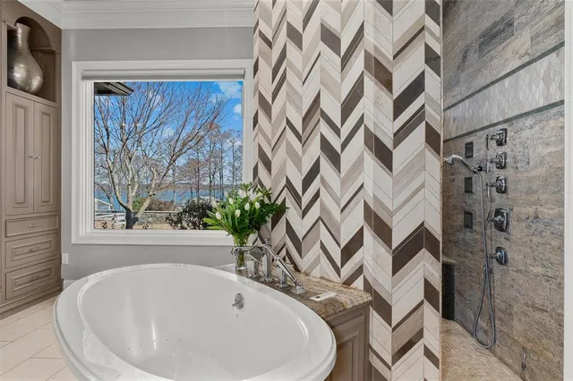 a white bath tub sitting next to a white curtain