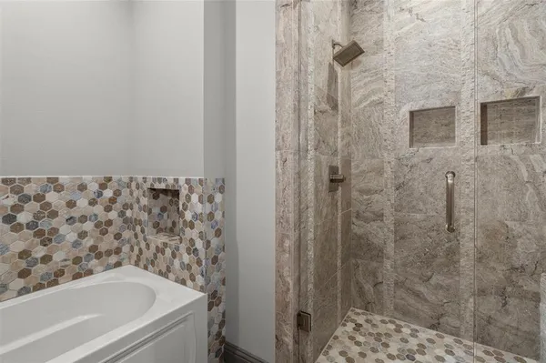 a bathroom with a bathtub and shower