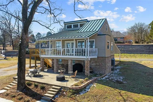 a view of house with swimming pool and patio