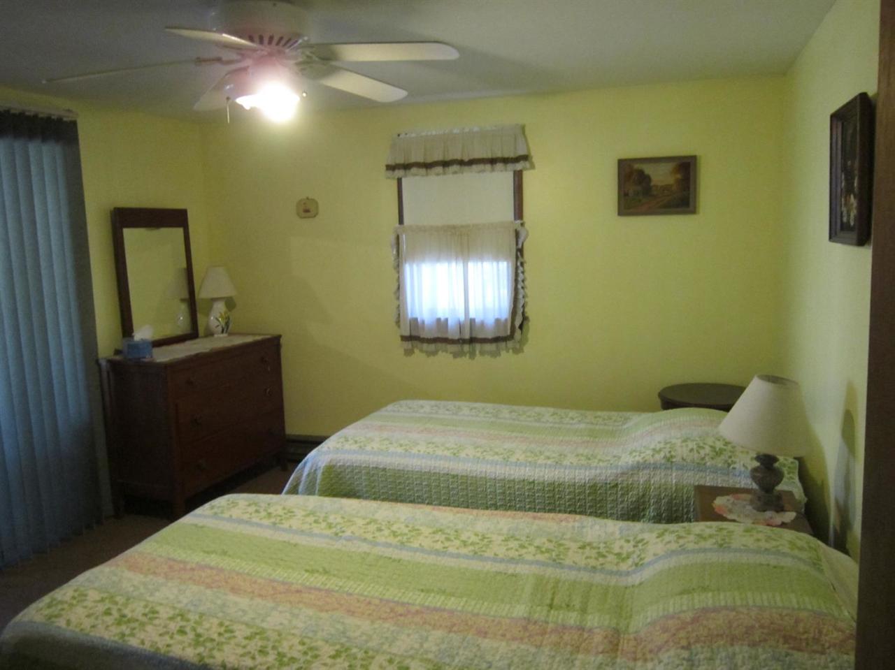 30 Bartlett Road Wellfleet, MA 02667 - Photo 11 of 12 a bedroom with a bed and a mirror on the dresser
