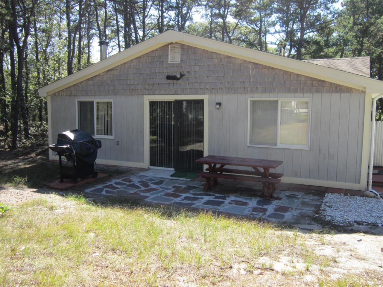 30 Bartlett Road Wellfleet, MA 02667 - Photo 3 of 12 a front view of house with yard outdoor seating and barbeque oven
