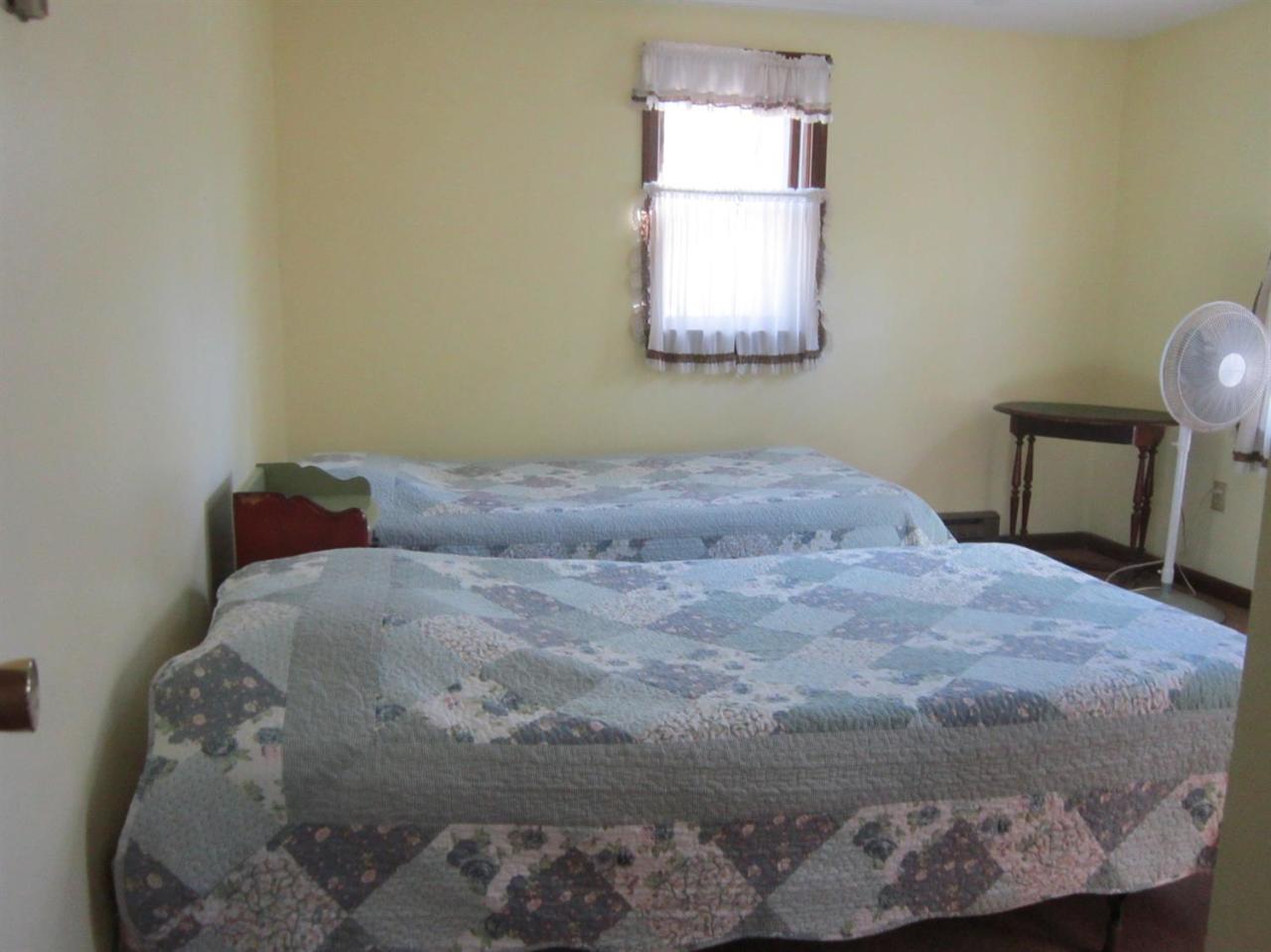 30 Bartlett Road Wellfleet, MA 02667 - Photo 9 of 12 a bed sitting in a bedroom next to a window