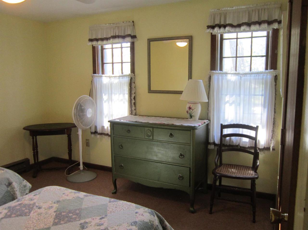 30 Bartlett Road Wellfleet, MA 02667 - Photo 10 of 12 a room with a chair and a window