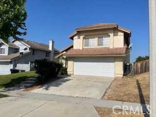 412 Yellowstone Circle Corona, CA 92879 - Photo 1 of 15 a front view of a house with a yard
