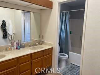 412 Yellowstone Circle Corona, CA 92879 - Photo 11 of 15 a bathroom with a granite countertop sink toilet and shower