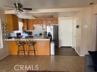 412 Yellowstone Circle Corona, CA 92879 - Photo 6 of 15 a kitchen with stainless steel appliances granite countertop a refrigerator a stove and a sink
