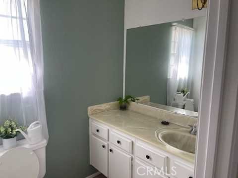 412 Yellowstone Circle Corona, CA 92879 - Photo 8 of 15 a bathroom with a granite countertop sink and a mirror