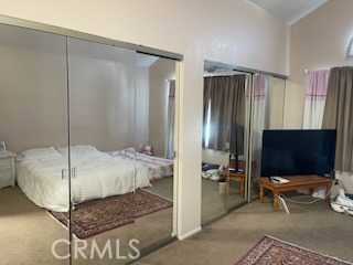 412 Yellowstone Circle Corona, CA 92879 - Photo 10 of 15 a living room with a bed and a flat screen tv