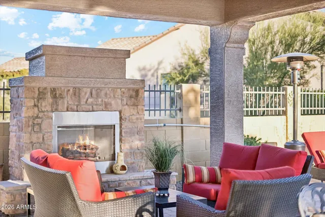 a living room with furniture a fireplace and a large window