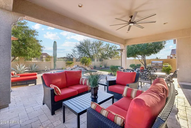 a view of an outdoor dining space with furniture and garden