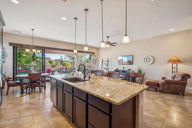 a spacious bedroom with a bed a chandelier and a large window