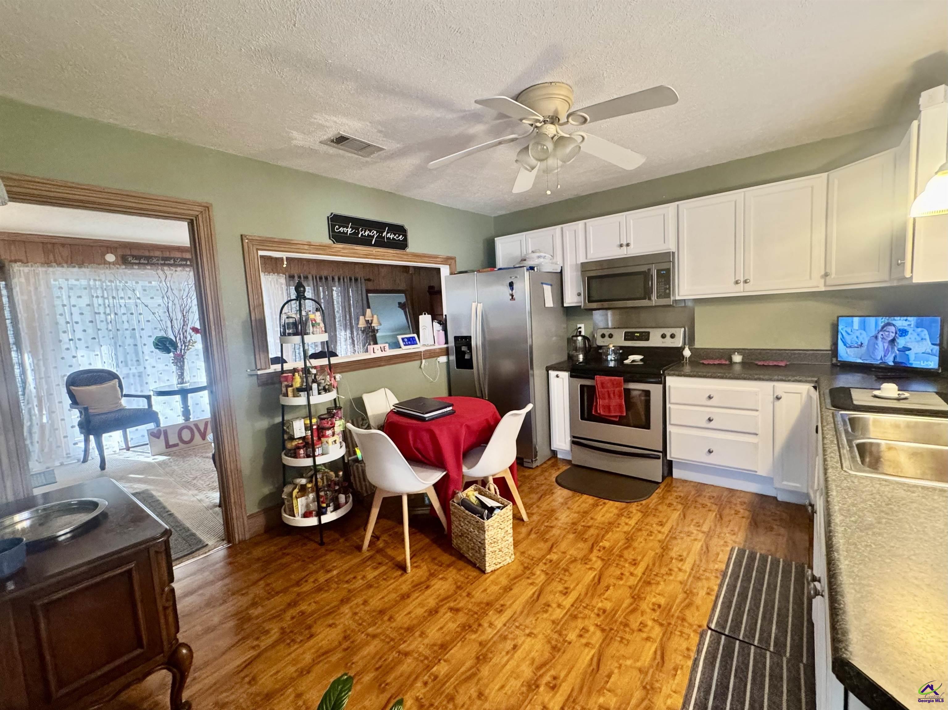 914 Adderton Street Americus, GA 31719 - Photo 33 of 53 a living room with lots of furniture and kitchen view