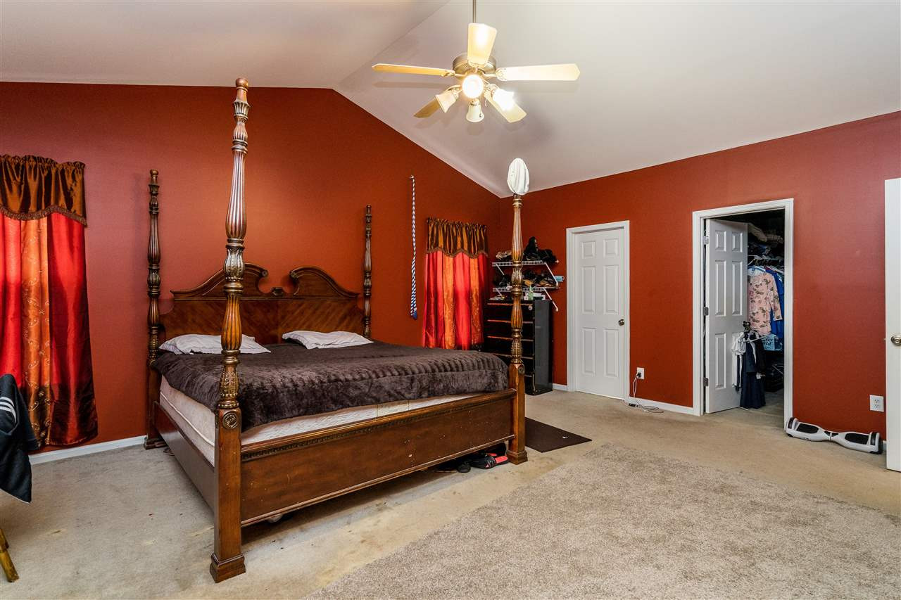 3130 Rendezvous Drive Raleigh, NC 27610 - Photo 13 of 22 a bed room with a bed and a chandelier