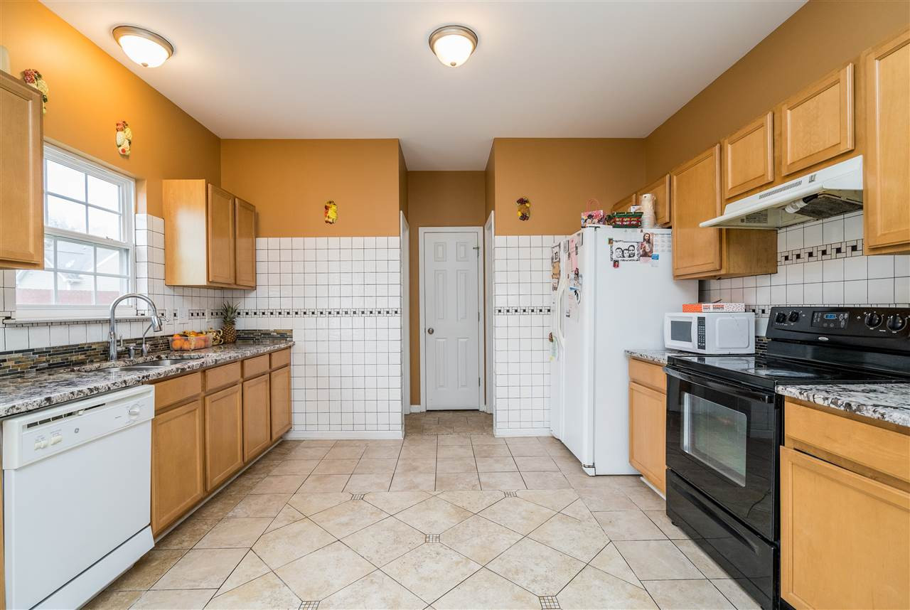 3130 Rendezvous Drive Raleigh, NC 27610 - Photo 5 of 22 a kitchen with stainless steel appliances granite countertop a stove a sink and a refrigerator