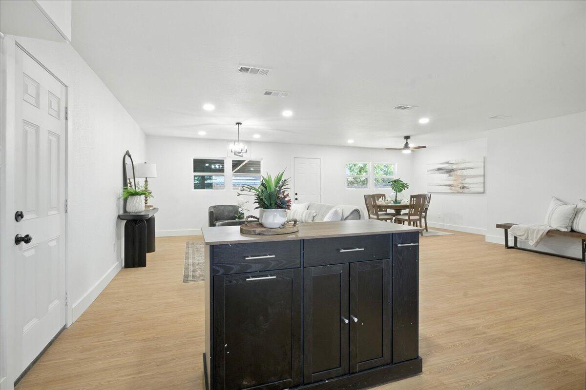 1308 59th Street Lubbock, TX 79412 - Photo 15 of 28 a kitchen with kitchen island granite countertop a sink and cabinets