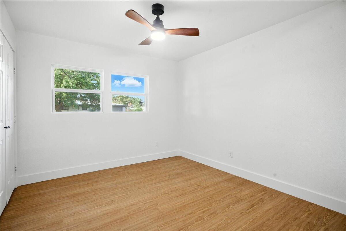 1308 59th Street Lubbock, TX 79412 - Photo 16 of 28 an empty room with a window and a ceiling fan