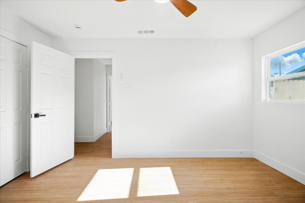 1308 59th Street Lubbock, TX 79412 - Photo 19 of 28 a view of a room with wooden floor and brick walls