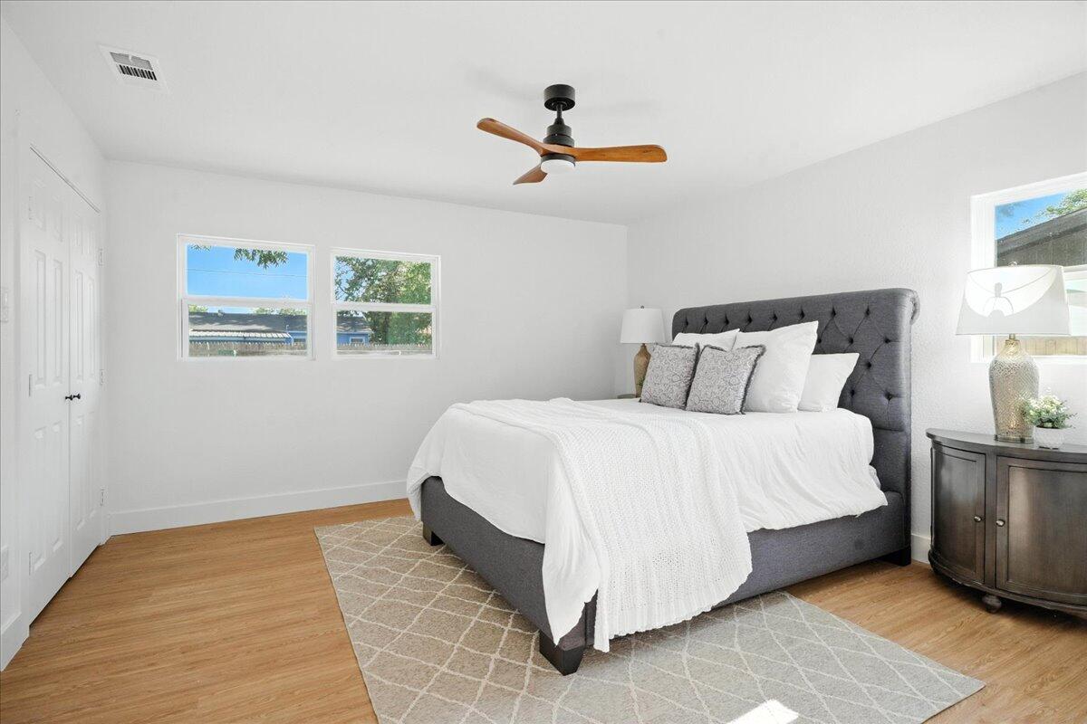 1308 59th Street Lubbock, TX 79412 - Photo 20 of 28 a bedroom with a bed and painting on the wall