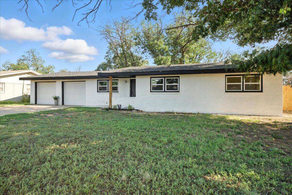 1308 59th Street Lubbock, TX 79412 - Photo 2 of 28 a view of a house with a backyard