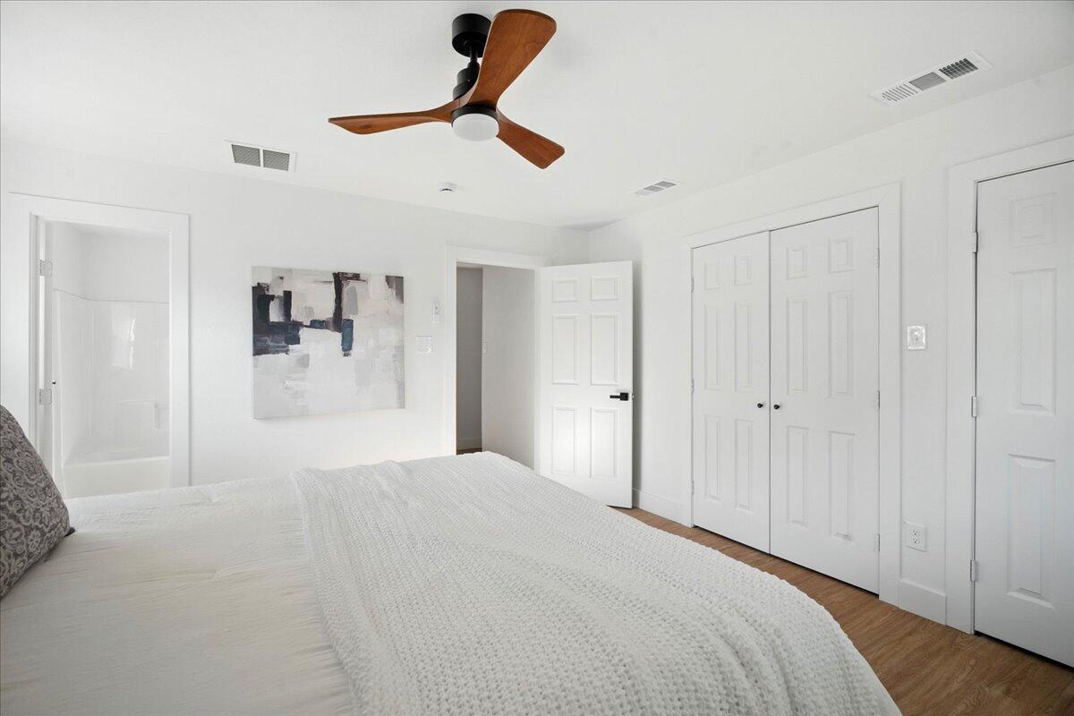 1308 59th Street Lubbock, TX 79412 - Photo 21 of 28 a bedroom with a large bed and ceiling fan