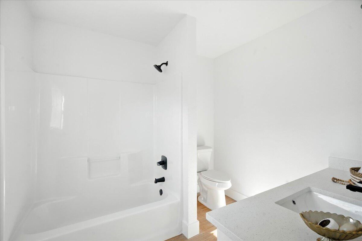 1308 59th Street Lubbock, TX 79412 - Photo 22 of 28 a bathroom with a bathtub and shower