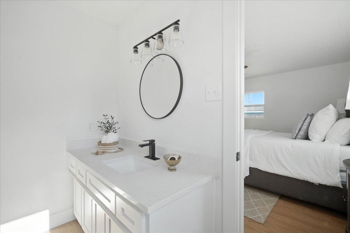 1308 59th Street Lubbock, TX 79412 - Photo 23 of 28 a en suite bathroom with a sink and a mirror