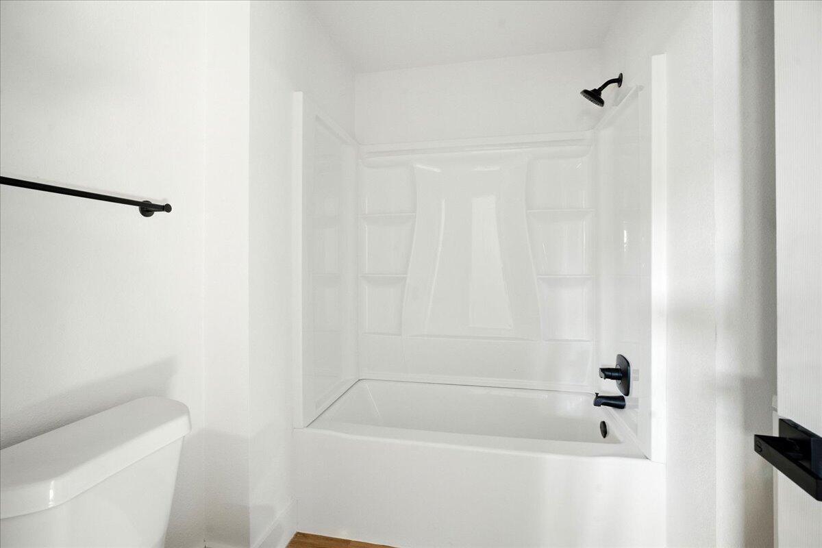 1308 59th Street Lubbock, TX 79412 - Photo 24 of 28 a bathroom with a shower and a bathtub