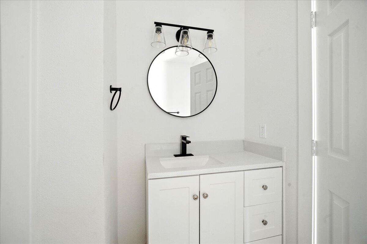 1308 59th Street Lubbock, TX 79412 - Photo 25 of 28 a bathroom with a sink and a mirror