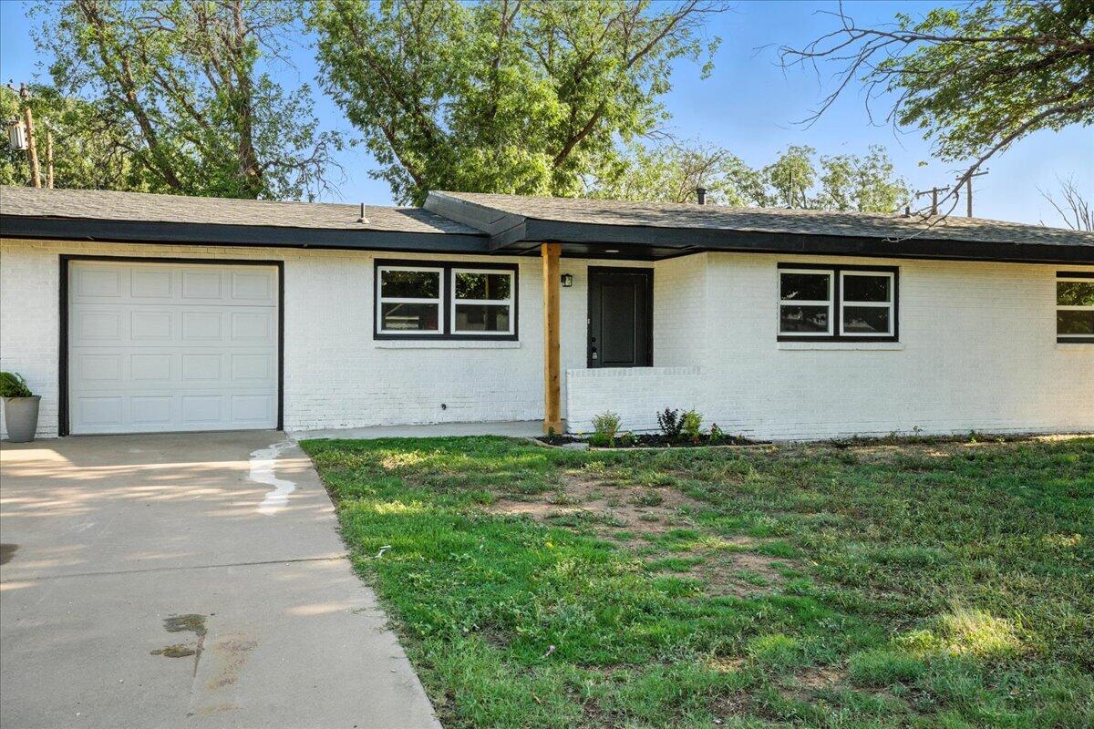 1308 59th Street Lubbock, TX 79412 - Photo 3 of 28 a house that has a lot of plants in it
