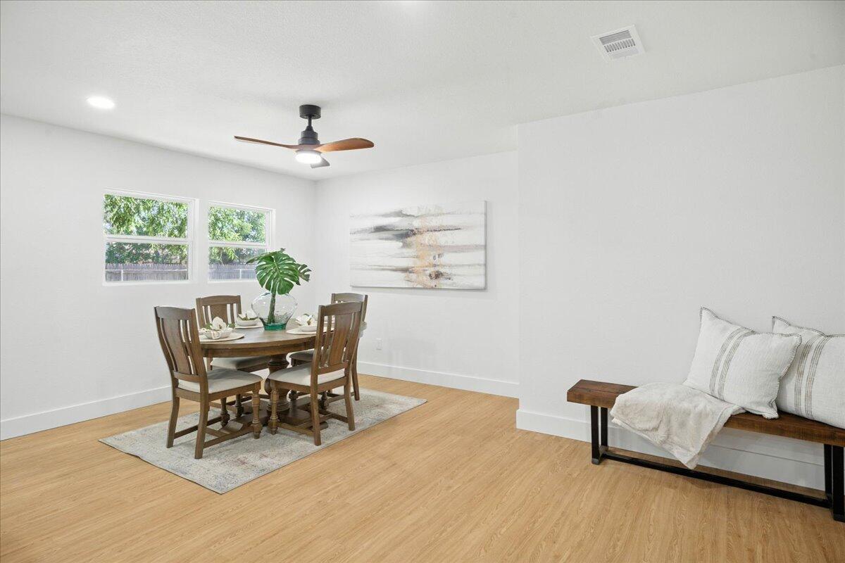 1308 59th Street Lubbock, TX 79412 - Photo 9 of 28 a dining room with furniture and a wooden floor