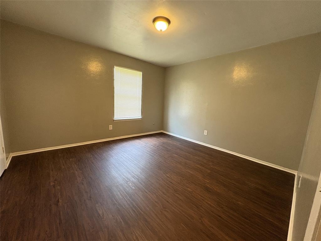 1702 Short Street, Unit C Cleburne, TX 76033 - Photo 5 of 9 a view of room and wooden floor