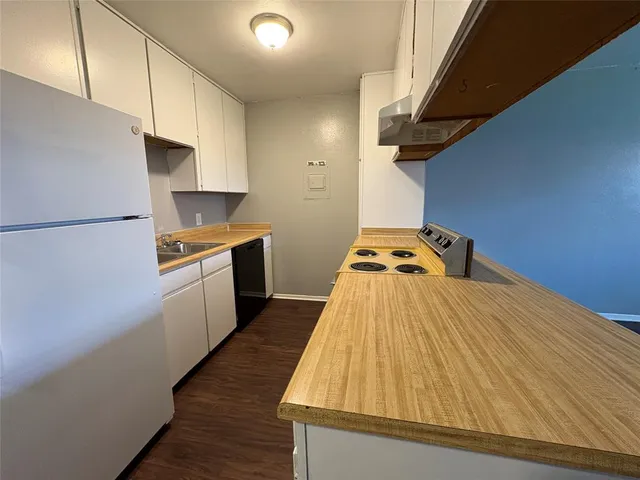 a kitchen with kitchen island a sink appliances and cabinets