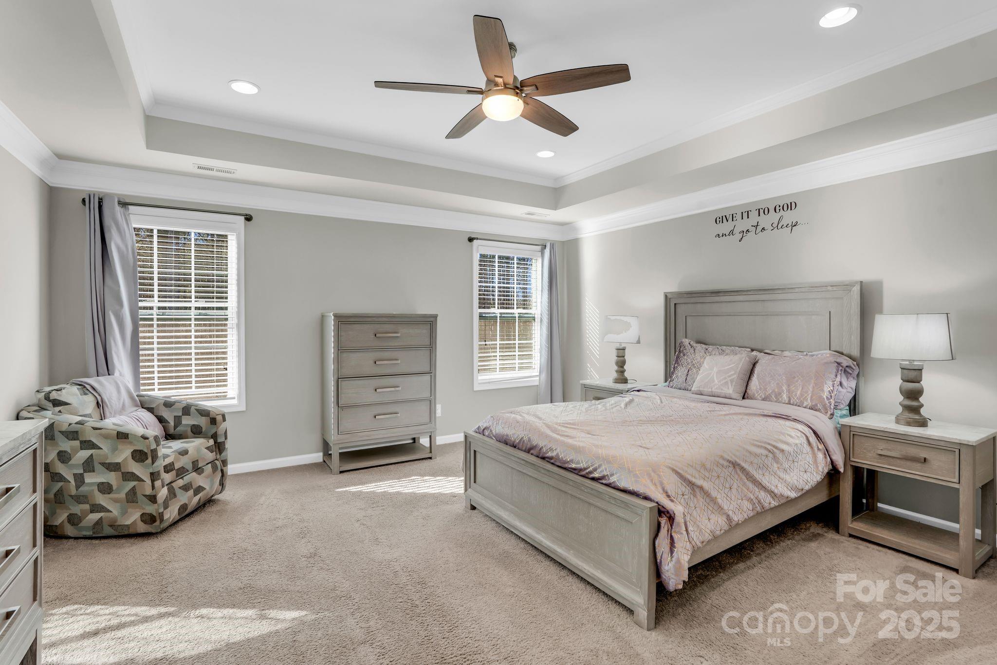 9507 Inverness Bay Road Charlotte, NC 28278 - Photo 15 of 29 a spacious bedroom with a bed a dresser and a chandelier