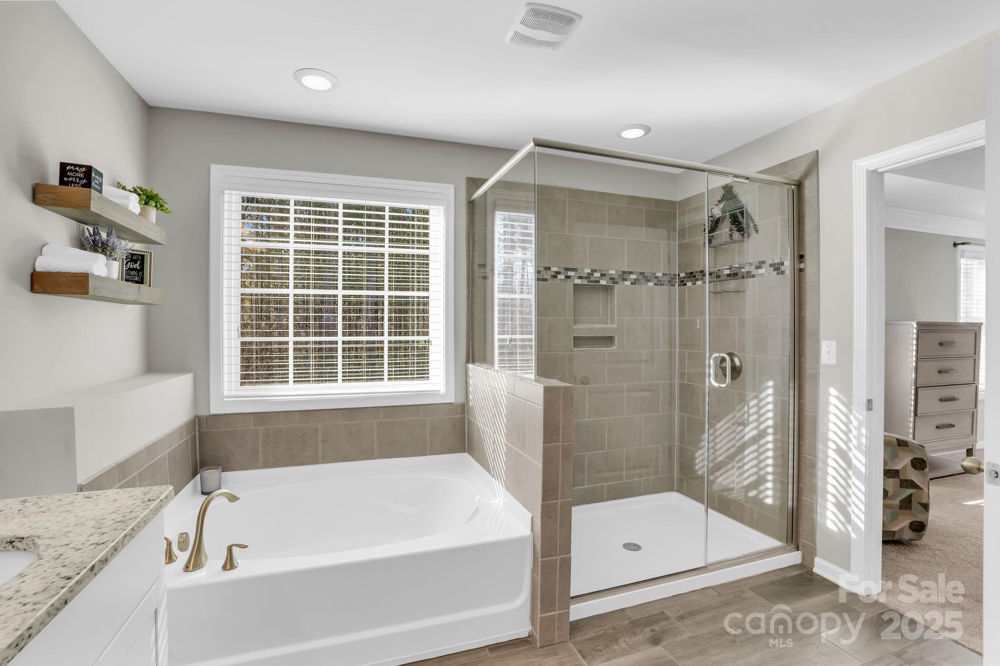 9507 Inverness Bay Road Charlotte, NC 28278 - Photo 17 of 29 a bathroom with a bathtub and a shower
