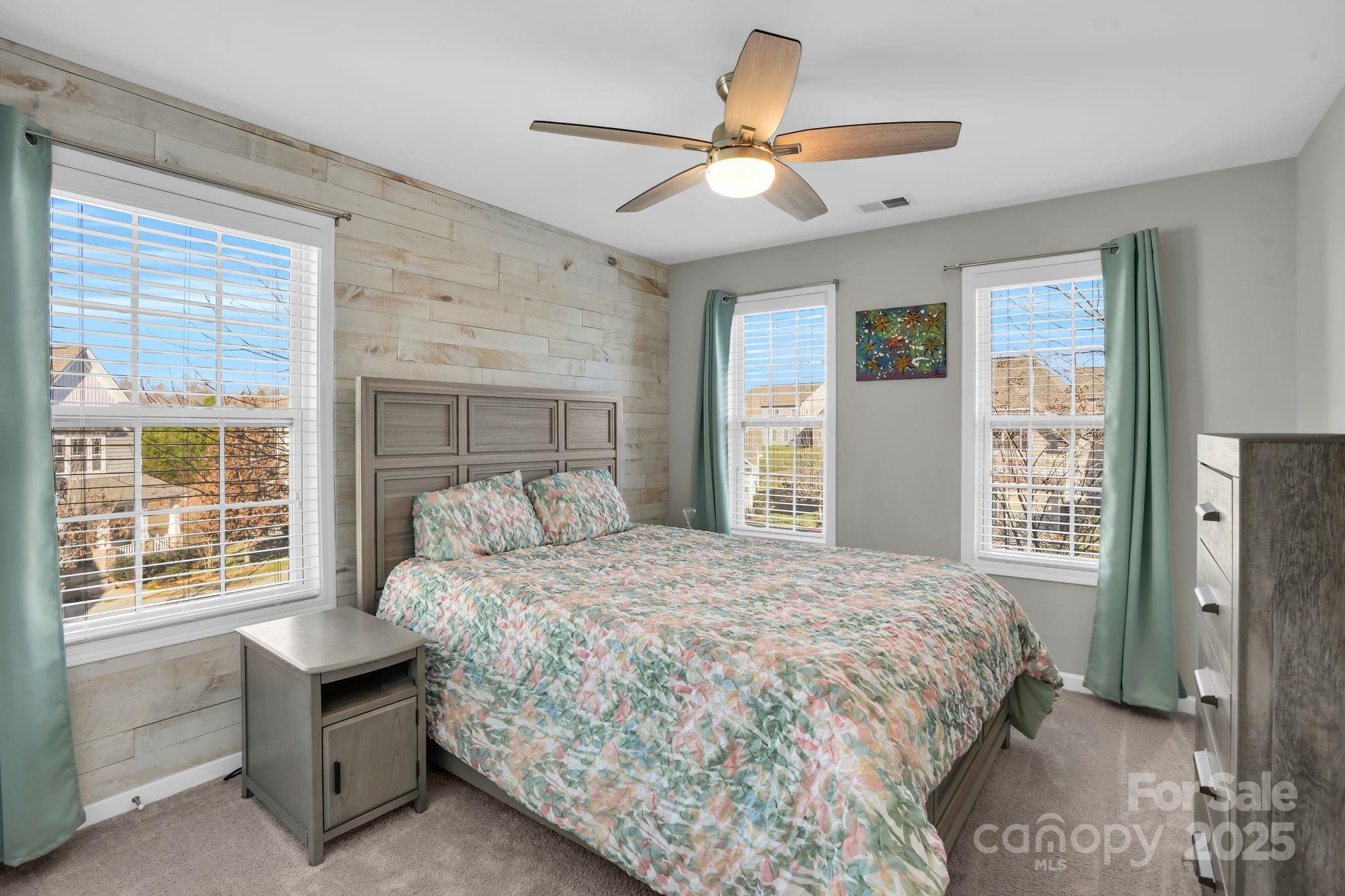 9507 Inverness Bay Road Charlotte, NC 28278 - Photo 18 of 29 a bedroom with a bed a window and a chandelier