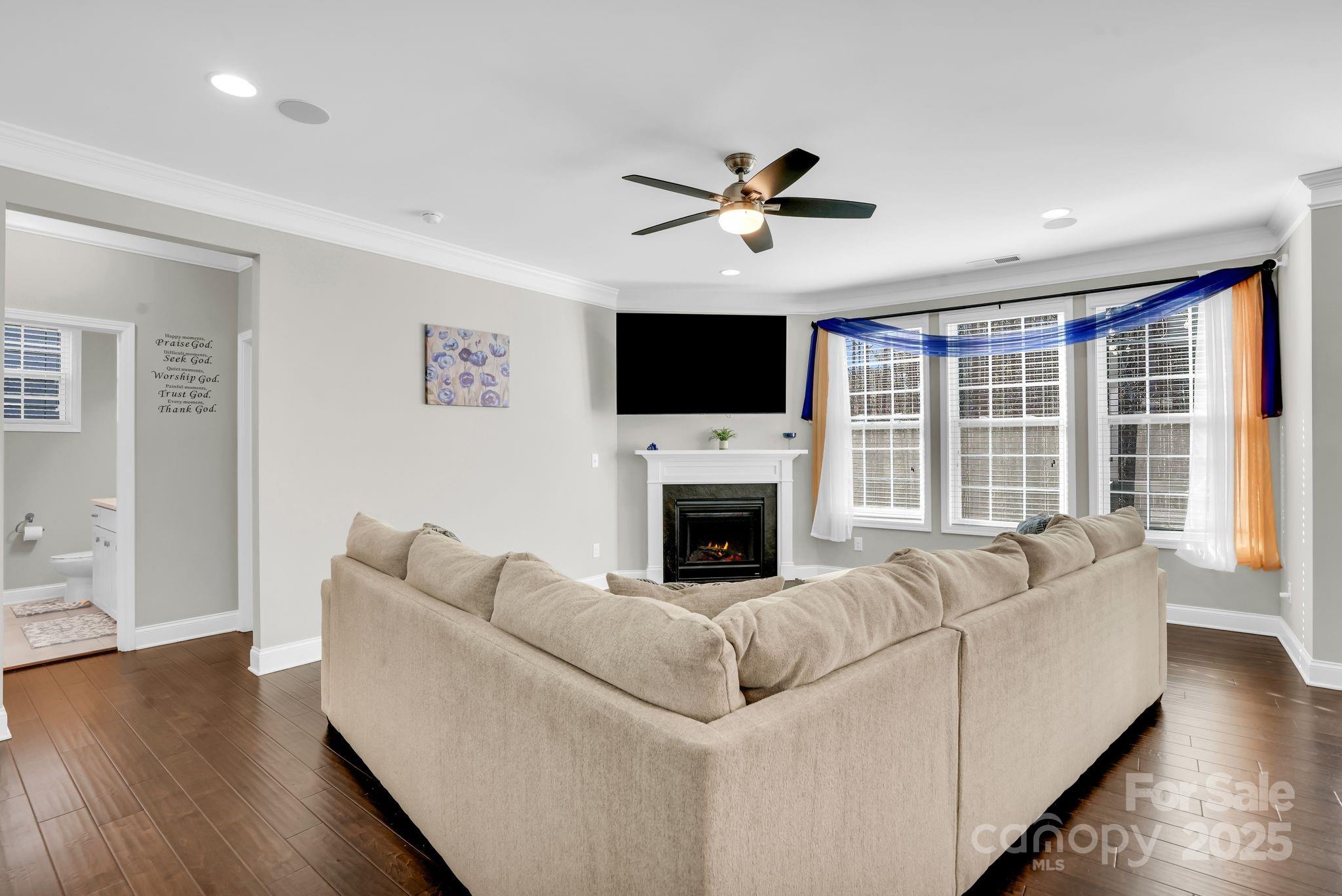 9507 Inverness Bay Road Charlotte, NC 28278 - Photo 5 of 29 a living room with furniture a fireplace and a flat screen tv