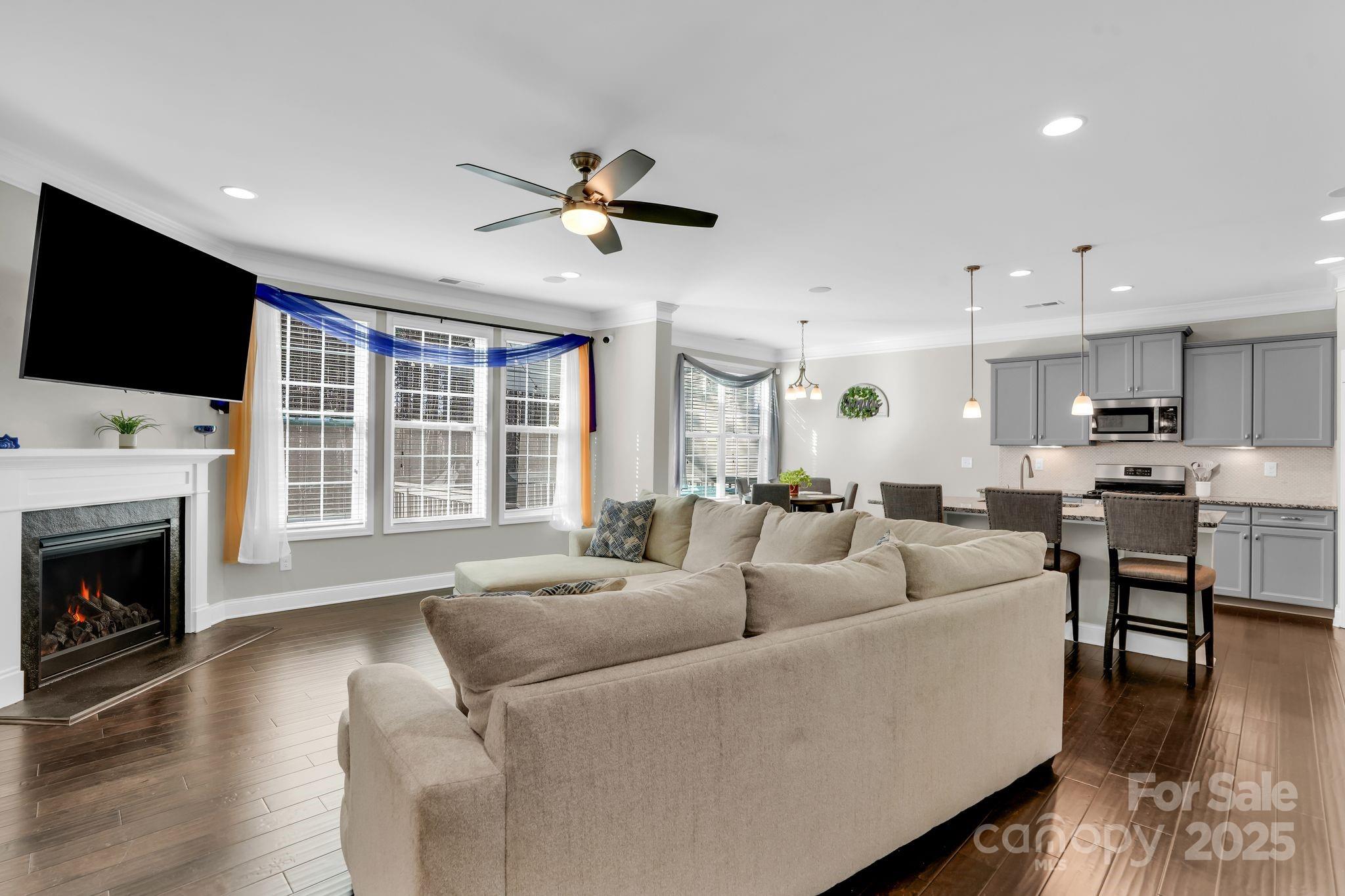 9507 Inverness Bay Road Charlotte, NC 28278 - Photo 7 of 29 a living room with fireplace furniture and a flat screen tv