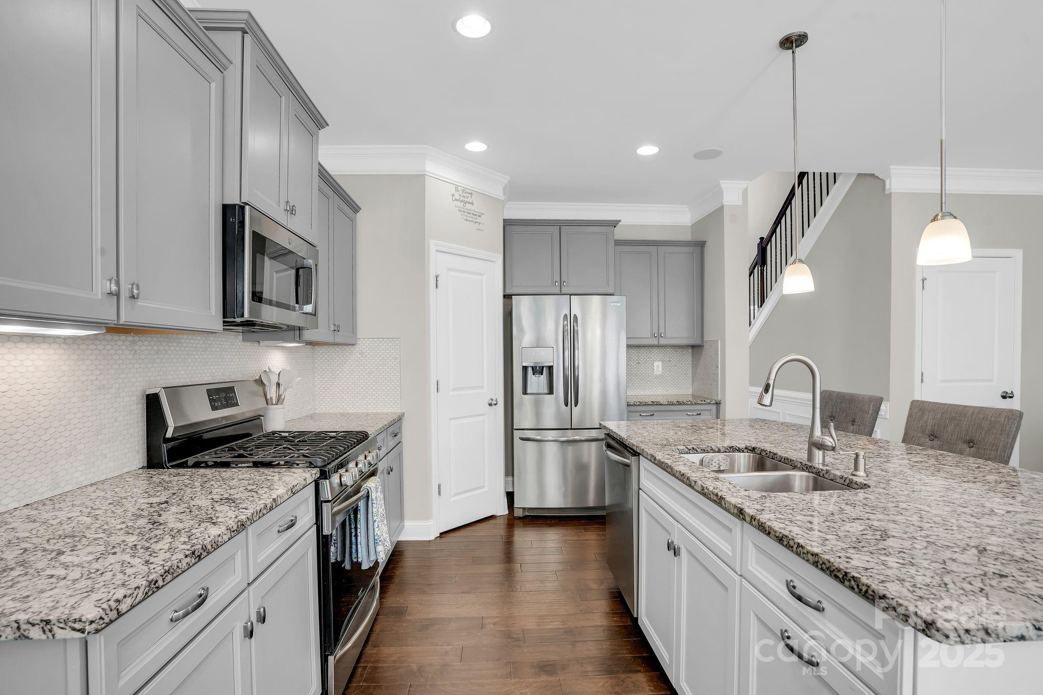 9507 Inverness Bay Road Charlotte, NC 28278 - Photo 10 of 29 a kitchen with stainless steel appliances granite countertop a sink a stove and a refrigerator