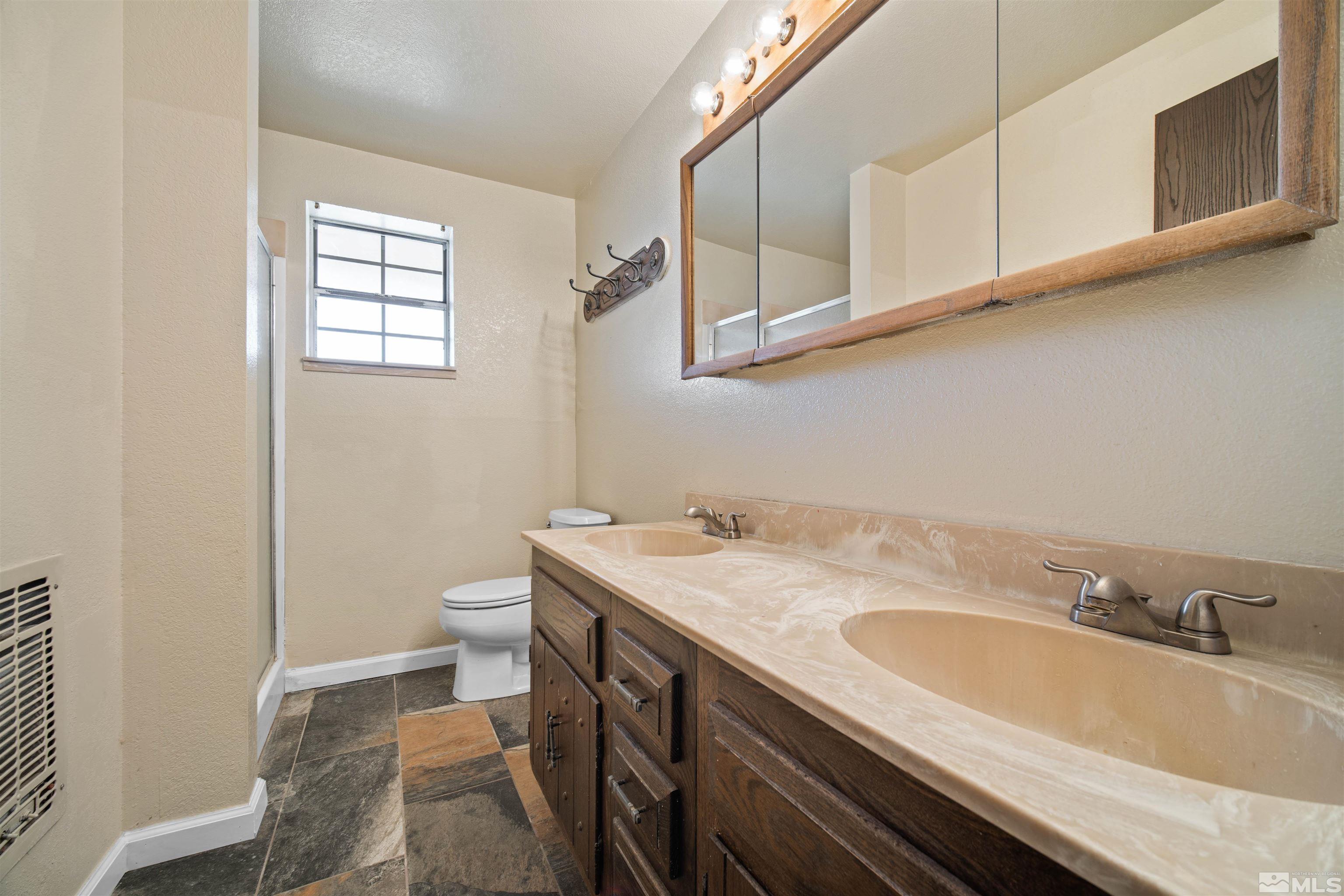 1960 Silverado Road Reno, NV 89521 - Photo 23 of 39 a bathroom with a sink a vanity and a toilet