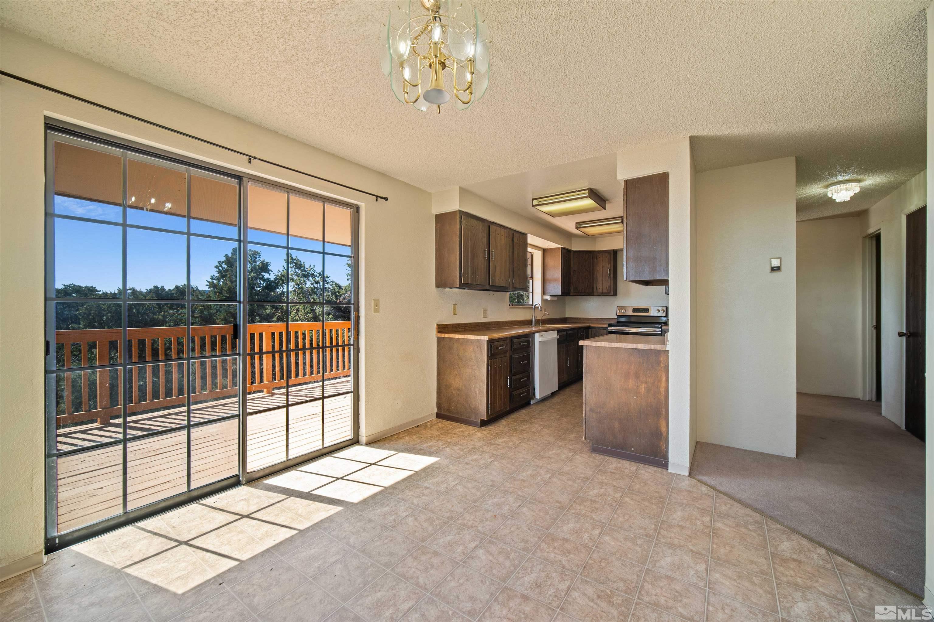 1960 Silverado Road Reno, NV 89521 - Photo 7 of 39 a kitchen with stainless steel appliances a stove top oven and a refrigerator